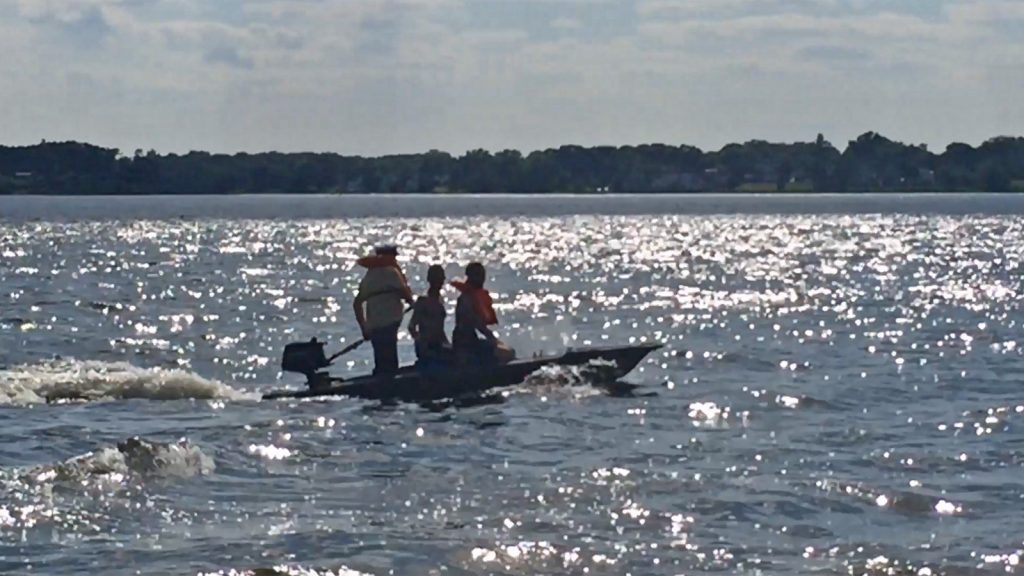 Micronautical Design - Three people in a motor kayak skiff