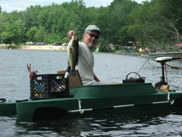 Dan holding a fish he caught in his motorized fishing kayak