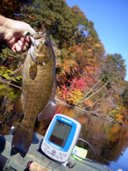 Rox holding fish in her kayak