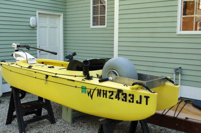 kayak for offshore fishing, rigged with electric motor and carry wheel