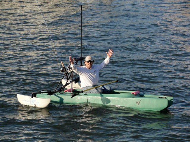 fly fisherman sitting in his stand up kayak