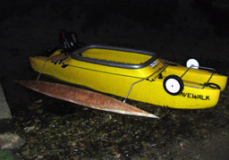 Motorized kayak with outriggers