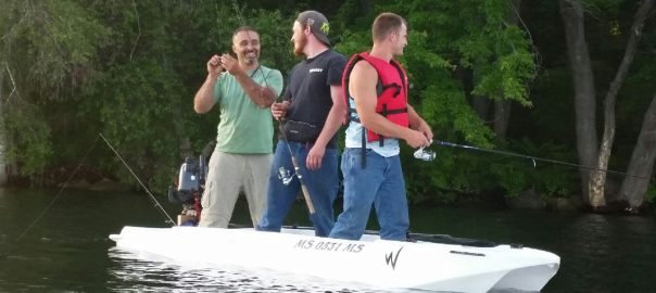 S4 motor kayak with three fishermen on board